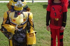 Two children dressed in Bumblebee and red character costumes pose at Cape Coral Kiwanis KidsFest 2025.