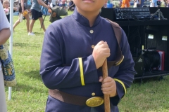 Child dressed in a historical military-style costume poses during Cape Coral Kiwanis KidsFest 2025.