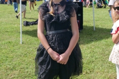 Child wearing a black dress costume poses during Cape Coral Kiwanis KidsFest 2025.