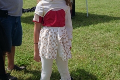 Child wearing a white and gold costume and boots poses during Cape Coral Kiwanis KidsFest 2025.