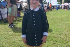 Child dressed in a black braided costume poses at Cape Coral Kiwanis KidsFest 2025.