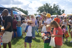 Families and children gather around vendor booths and attractions at Cape Coral Kiwanis KidsFest 2025.