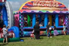 Children and families participate in the Midway Madness inflatable carnival games at Cape Coral Kiwanis KidsFest 2025.