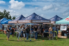 Visitors gather around the Cape Coral Kiwanis information tent during Cape Coral Kiwanis KidsFest 2025.