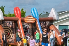 Families participate in the inflatable axe throw challenge game during Cape Coral Kiwanis KidsFest 2025.