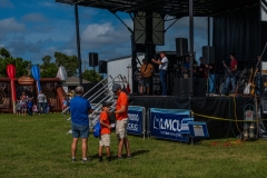 Families watch performers and speakers on the main entertainment stage during Cape Coral Kiwanis KidsFest 2025.