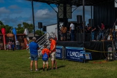 Families stand near the KidsFest stage while performers prepare for entertainment during Cape Coral Kiwanis KidsFest 2025.