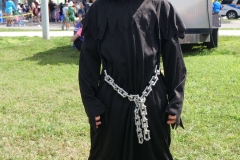 Child wearing a black reaper-style costume smiles for a portrait at Cape Coral Kiwanis KidsFest 2025.