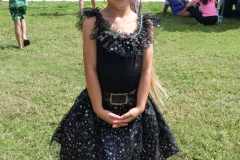 Child dressed in a black sparkly witch-style costume poses during Cape Coral Kiwanis KidsFest 2025.