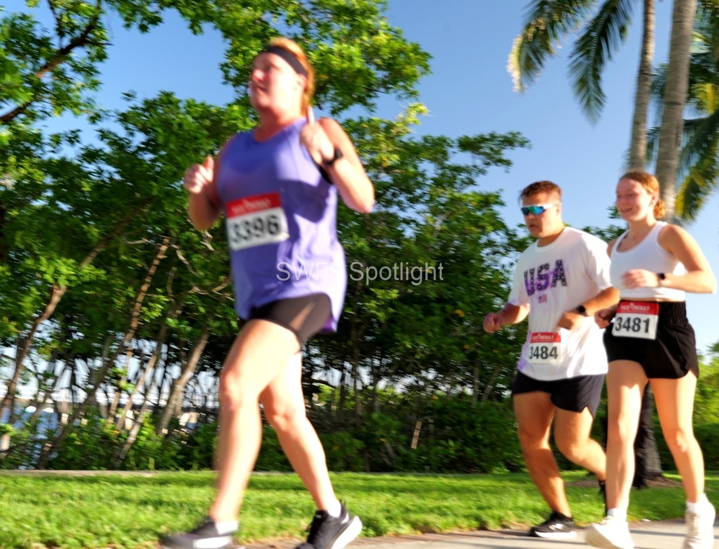 Participants run along the scenic waterfront route during the Purple Color Run in Fort Myers.