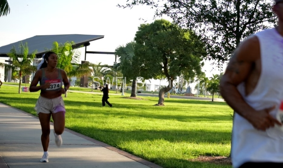 Runner competes during the Purple Color Run at Centennial Park in Fort Myers.