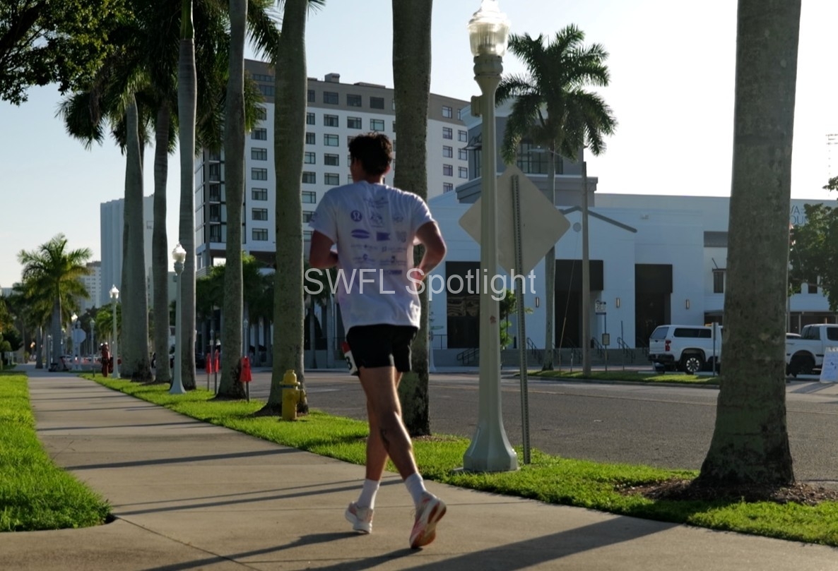 Runner makes their way through Downtown Fort Myers during the Purple Color Run charity 5K.