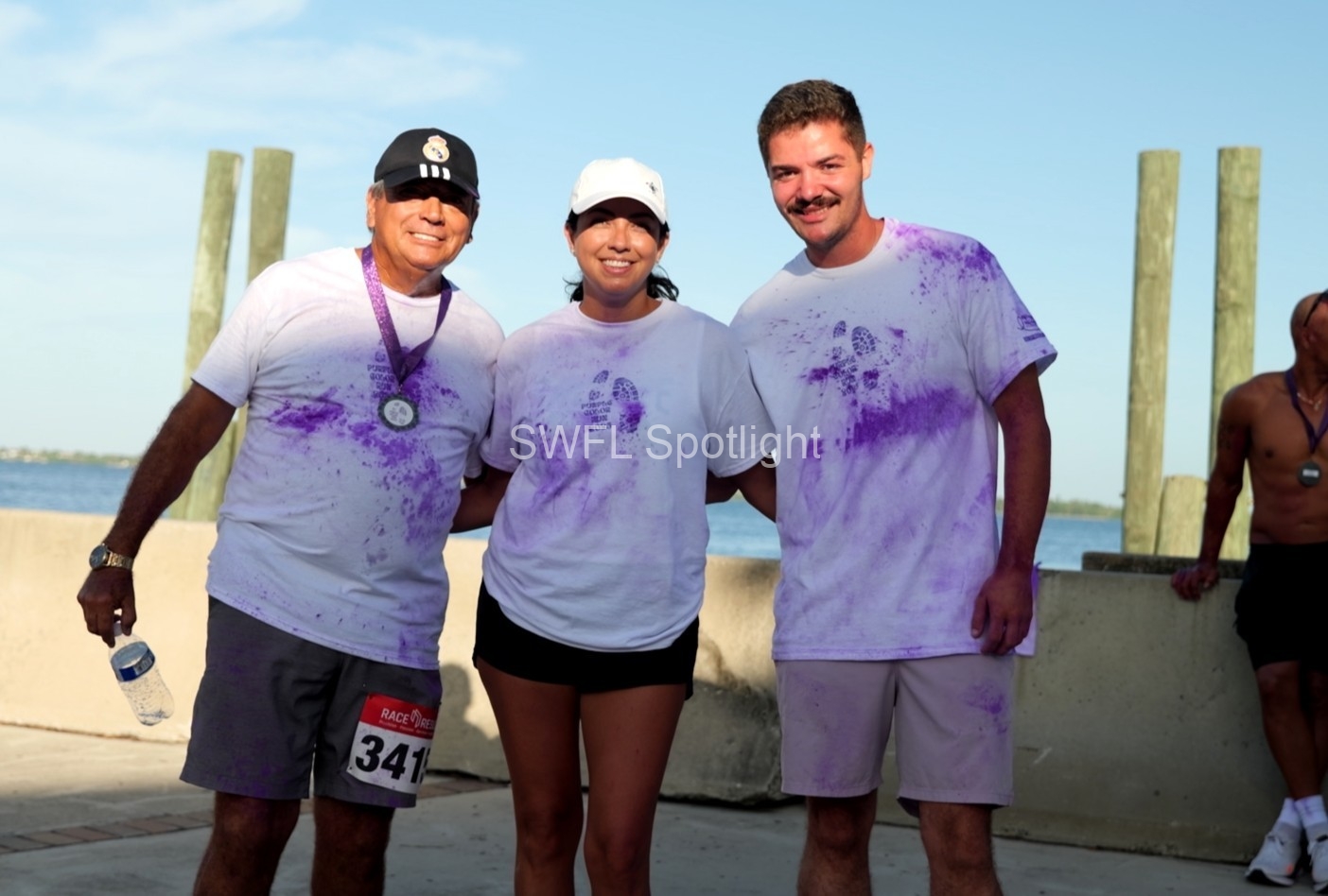Purple Color Run participants pose together after finishing the inaugural charity race in Fort Myers.