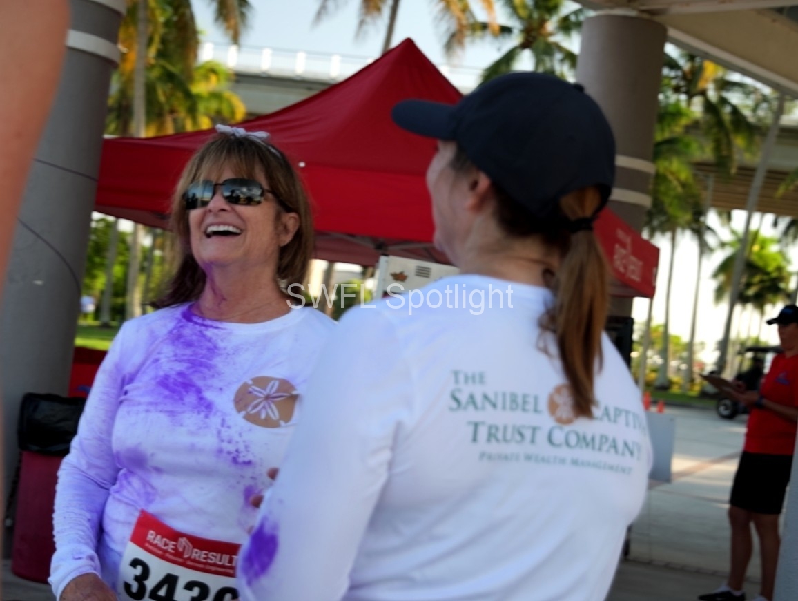 Purple Color Run participant chats with another attendee after the race in Fort Myers.