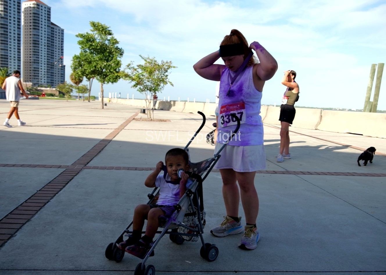 Parent and child participate in the Purple Color Run at Centennial Park in Fort Myers.