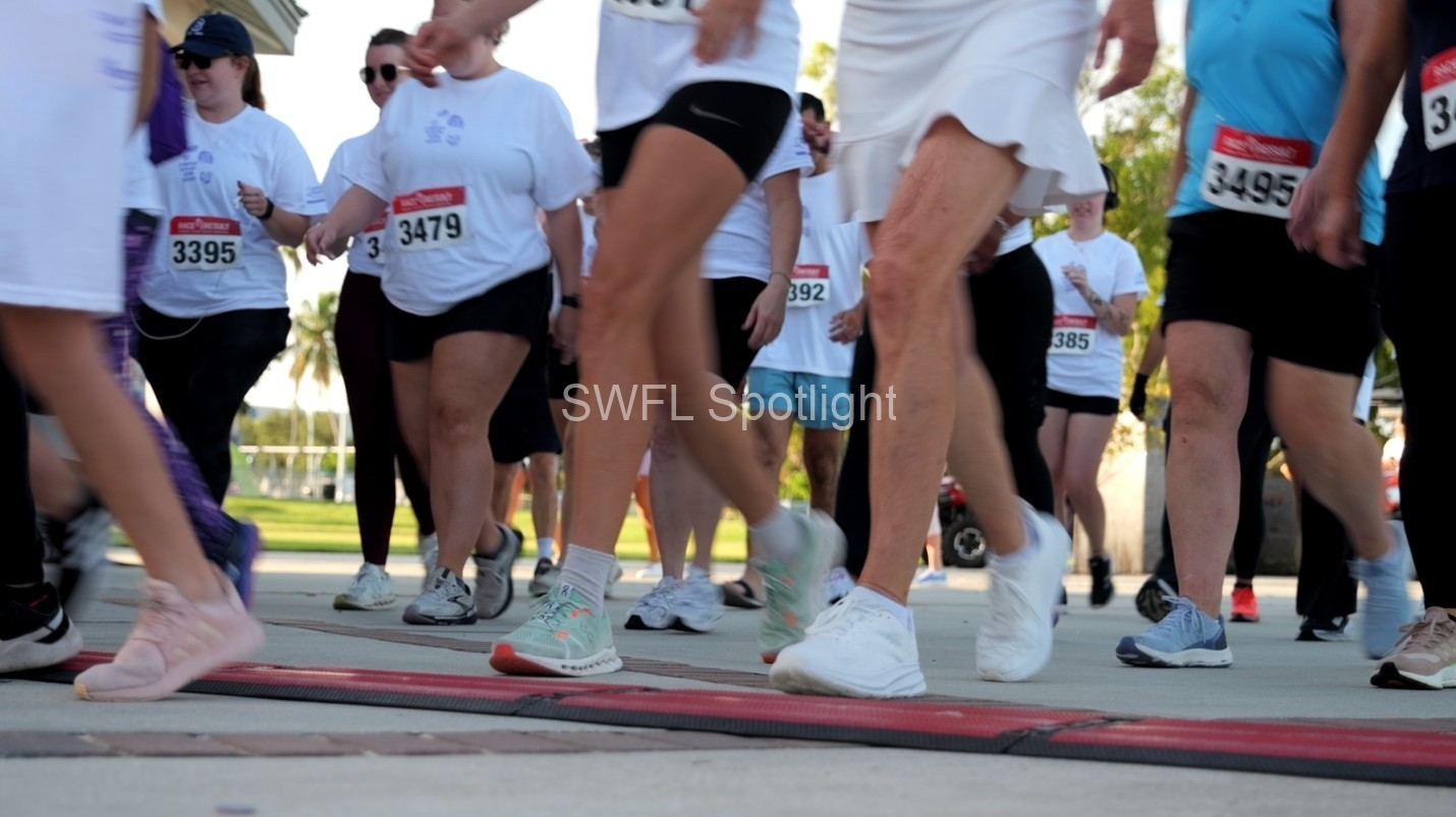 Participants cross the starting line as the inaugural Purple Color Run begins in Downtown Fort Myers.