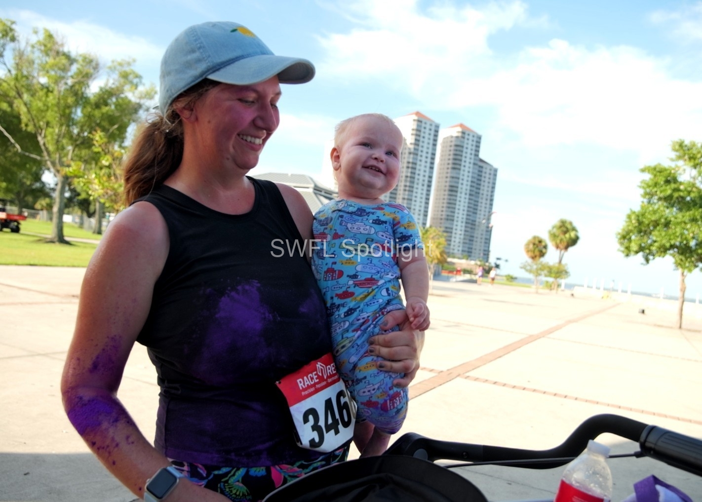Parent and child enjoy the Purple Color Run together in Downtown Fort Myers.