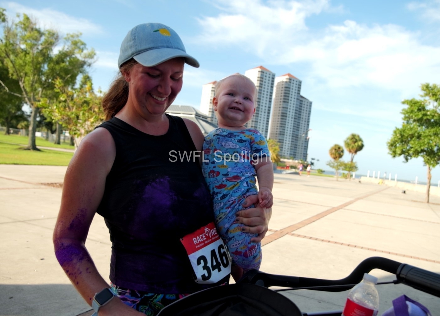 Parent and child celebrate after the Purple Color Run in Fort Myers.