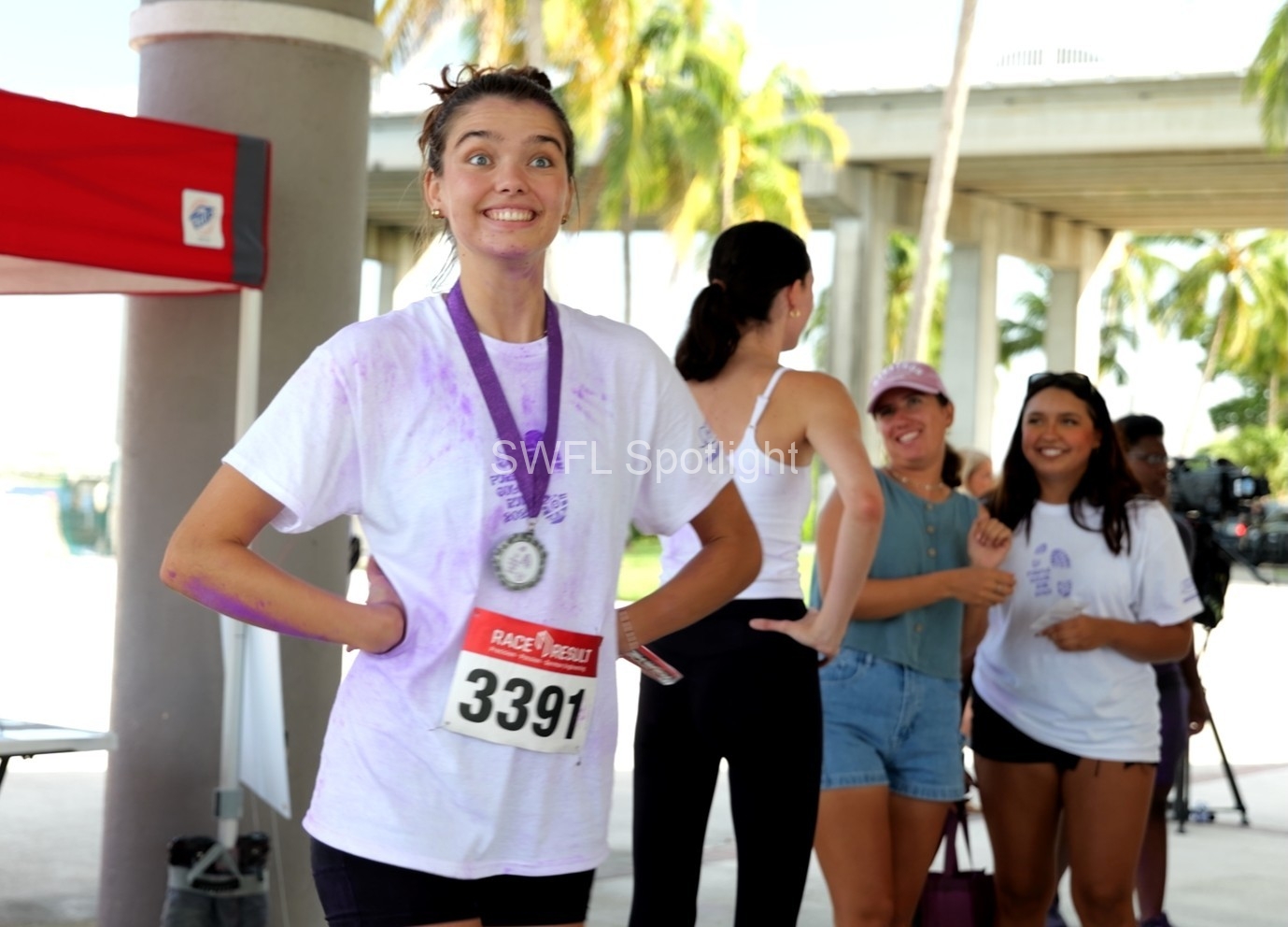 Purple Color Run participant smiles after completing the inaugural epilepsy awareness 5K in Fort Myers
