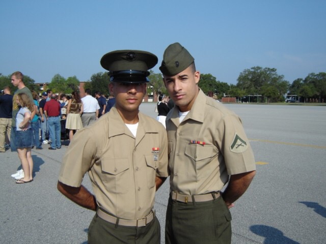 Nick Romero and another Marine pose in uniform during military service.
