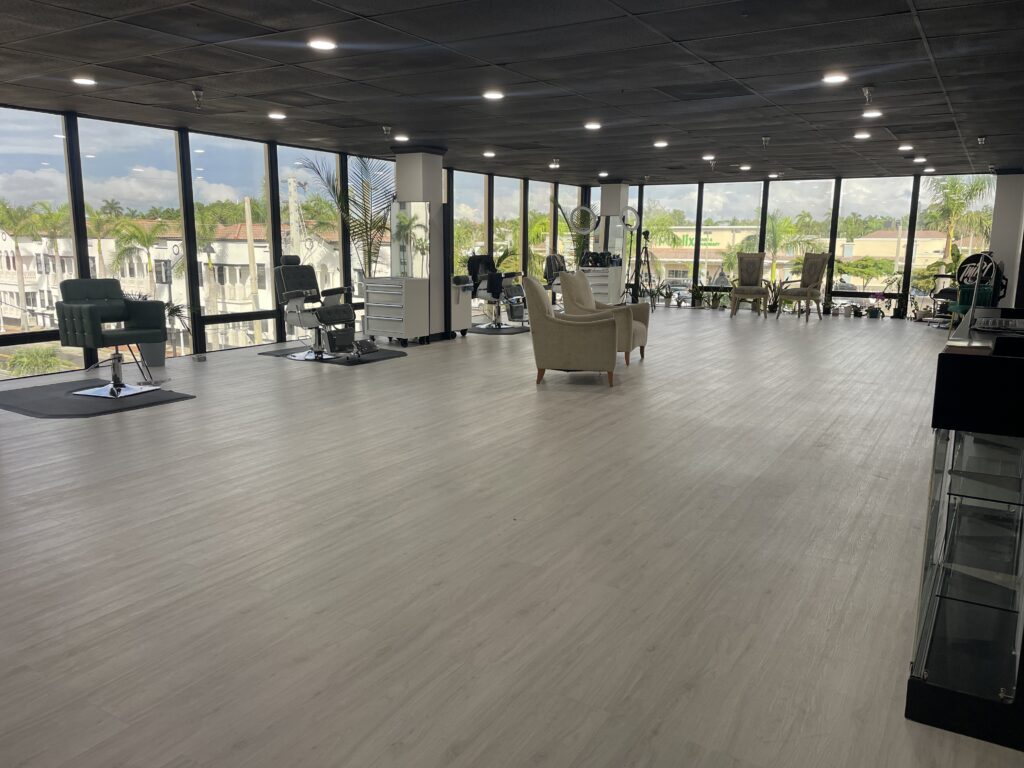 Interior of Thank My Barber barbershop in downtown Fort Myers with chairs and large windows.