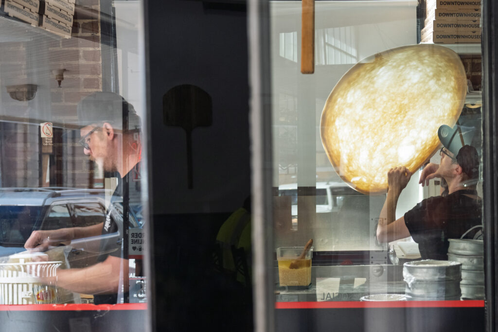 Pizza toss at Downtown House of Pizza during River District Music Walk