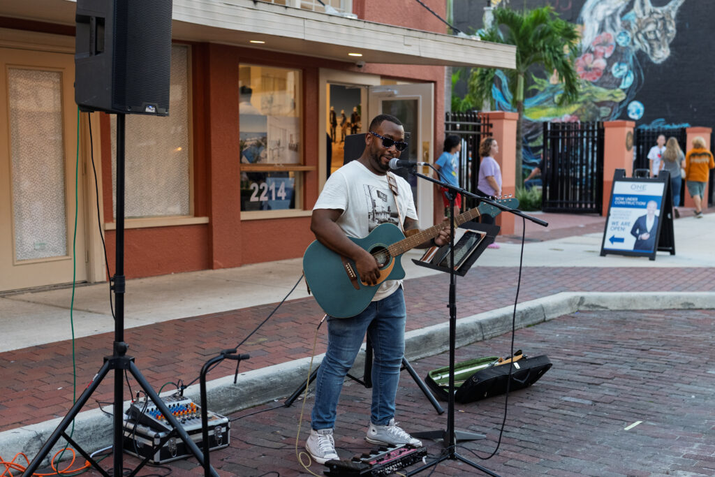 Solo musician performing during River District Music Walk